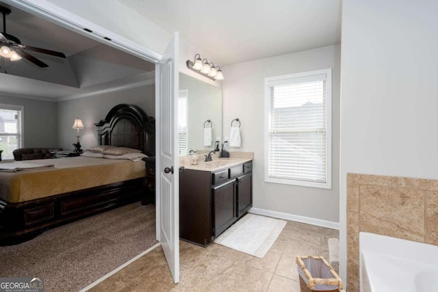 bathroom featuring tile patterned floors, crown molding, vanity, a washtub, and ceiling fan