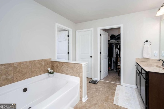 bathroom featuring vanity and a washtub