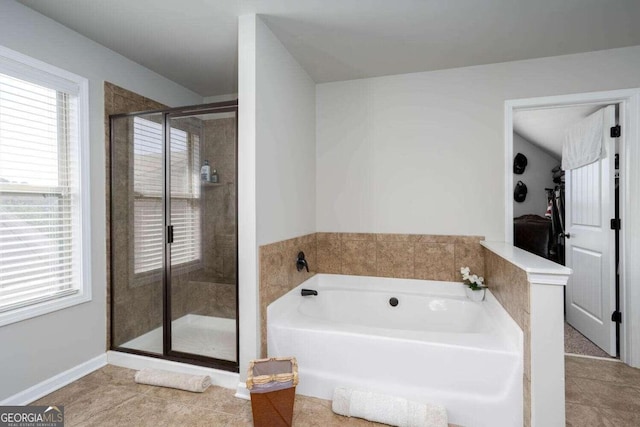 bathroom featuring tile patterned flooring and shower with separate bathtub