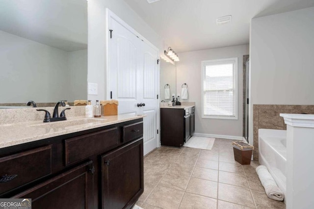 bathroom featuring vanity, tile patterned floors, and a bathtub