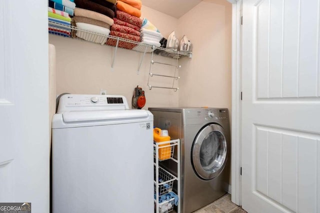 clothes washing area featuring washer and clothes dryer