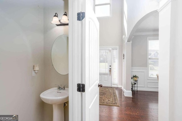 bathroom featuring ornamental molding and wood-type flooring