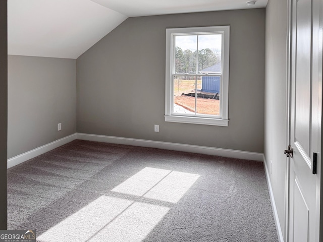 additional living space featuring lofted ceiling, baseboards, and carpet floors