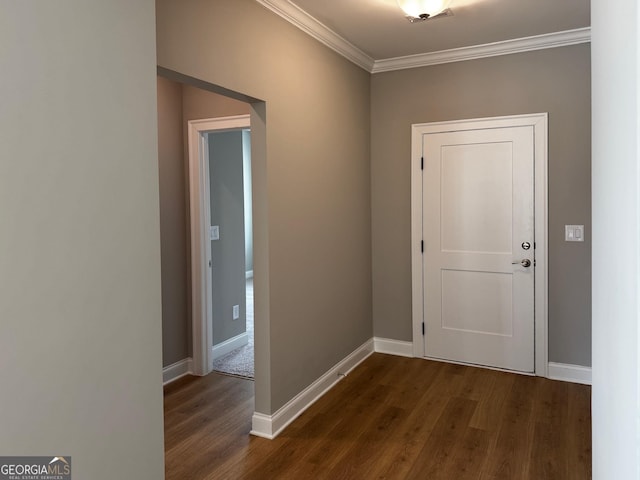 doorway to outside with baseboards, dark wood-style flooring, and crown molding