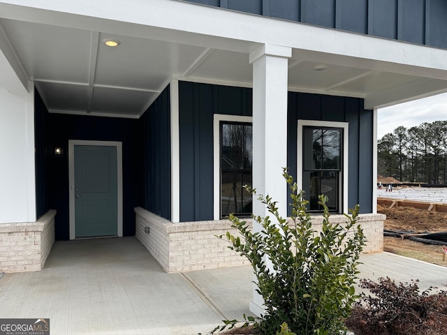 view of exterior entry featuring board and batten siding