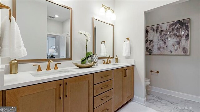 bathroom with vanity and toilet