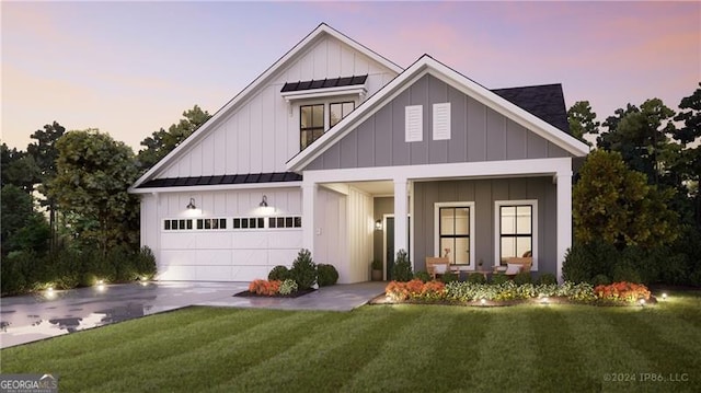 view of front facade with a garage and a lawn