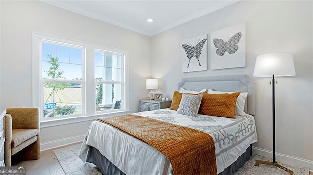 bedroom featuring light hardwood / wood-style floors and crown molding