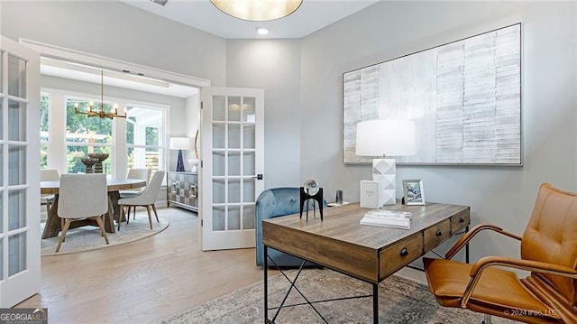 office space featuring a notable chandelier and light hardwood / wood-style floors