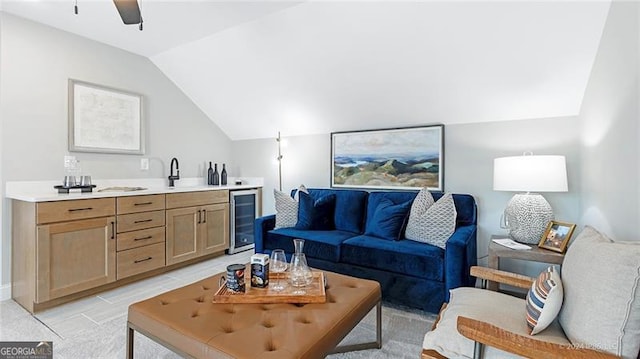 living room featuring vaulted ceiling, wine cooler, sink, and ceiling fan