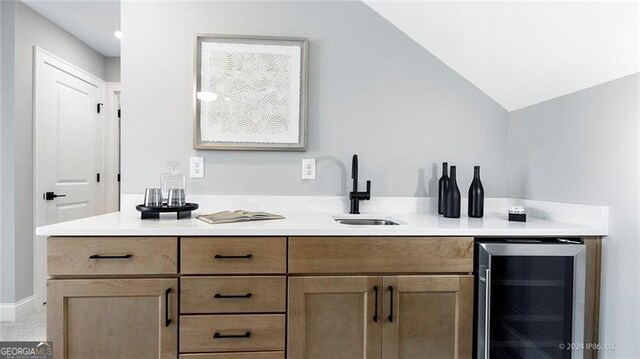 bathroom featuring beverage cooler, lofted ceiling, and vanity