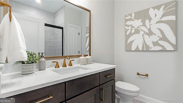 bathroom featuring vanity, toilet, and walk in shower