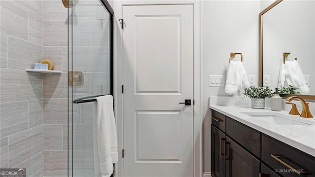 bathroom with a shower with door and vanity