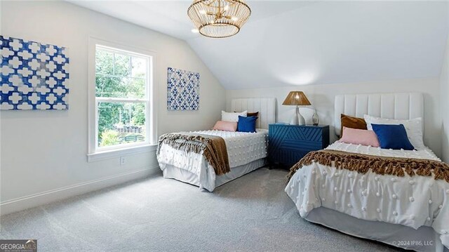 bedroom featuring multiple windows, lofted ceiling, and carpet flooring