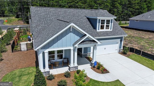 view of front of home featuring a garage and a porch