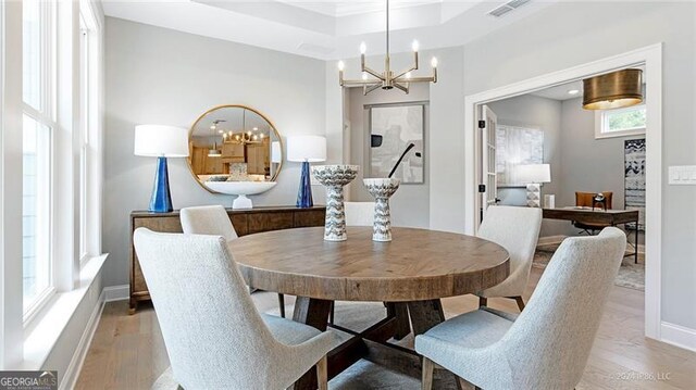 dining room with a notable chandelier and light hardwood / wood-style floors