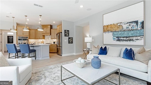 living room with light hardwood / wood-style flooring