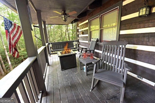 wooden terrace featuring ceiling fan