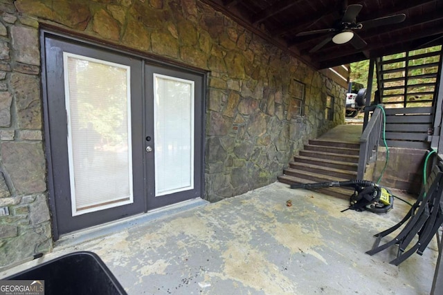 property entrance featuring ceiling fan, a patio area, and french doors