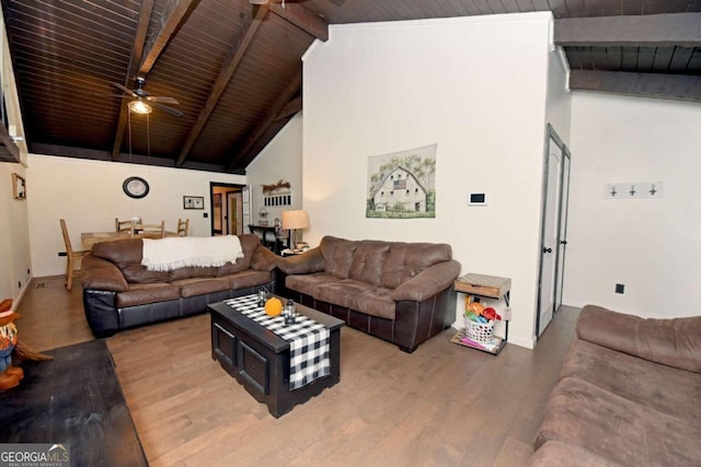 living room with wood ceiling, ceiling fan, wood-type flooring, and vaulted ceiling with beams