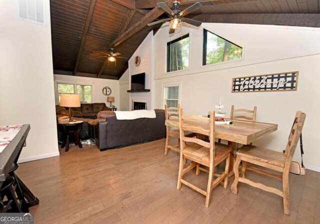 dining space with plenty of natural light, ceiling fan, and a large fireplace