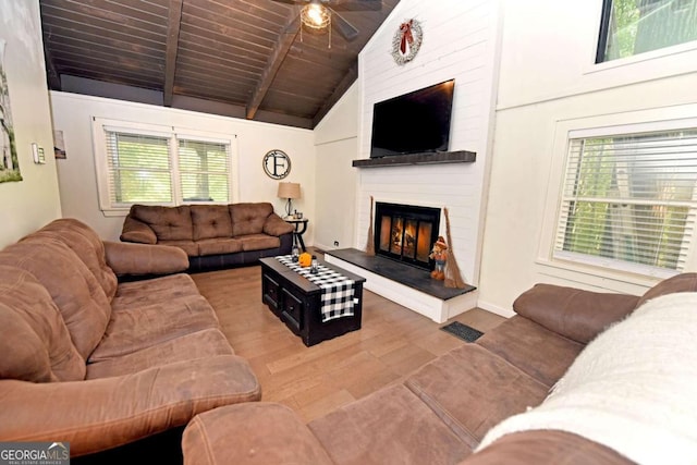 living room with plenty of natural light, hardwood / wood-style flooring, and a fireplace