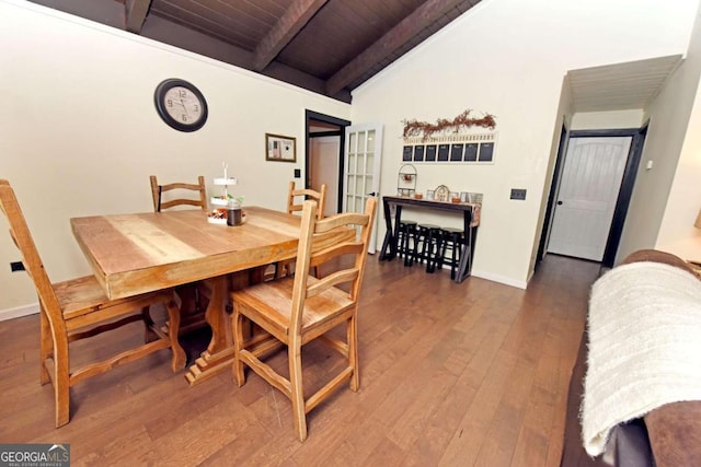 dining room with dark hardwood / wood-style floors, lofted ceiling with beams, and wooden ceiling