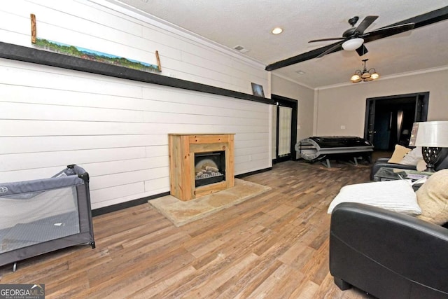 bedroom featuring ceiling fan, hardwood / wood-style flooring, a textured ceiling, and ornamental molding