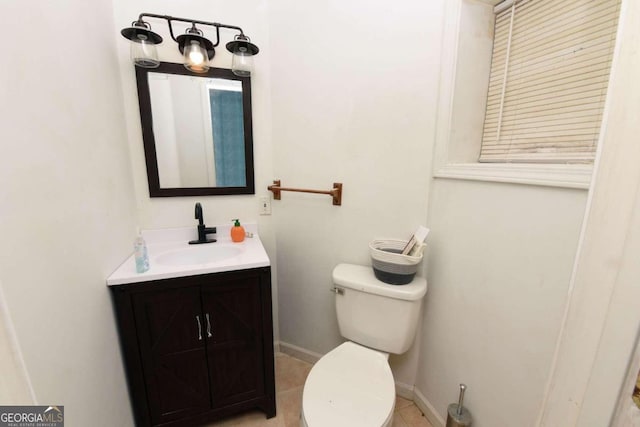 bathroom featuring vanity, toilet, and tile patterned flooring