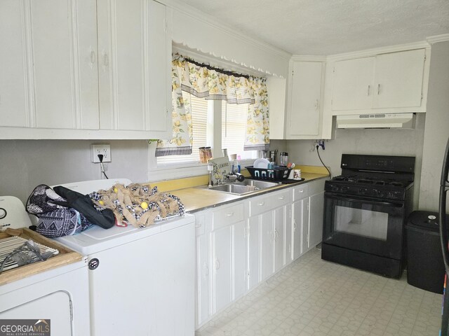 interior space featuring separate washer and dryer, white cabinetry, sink, ventilation hood, and black range with gas stovetop