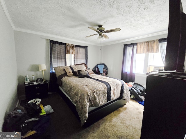 carpeted bedroom featuring ceiling fan, ornamental molding, and a textured ceiling