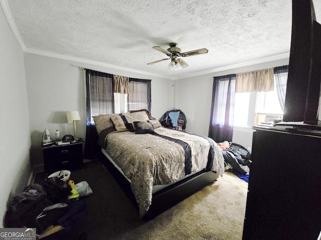 bedroom featuring carpet, ornamental molding, a ceiling fan, and a textured ceiling