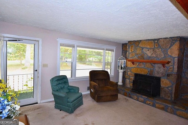 sitting room with a fireplace, a textured ceiling, a healthy amount of sunlight, and carpet flooring