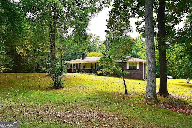 ranch-style home featuring a front yard