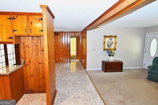 corridor with crown molding and wood walls