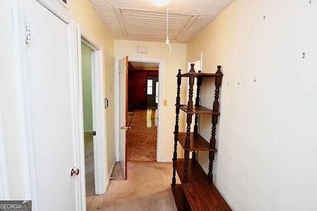 hallway with a textured ceiling