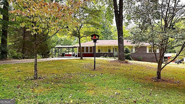 ranch-style house with a front lawn and a carport