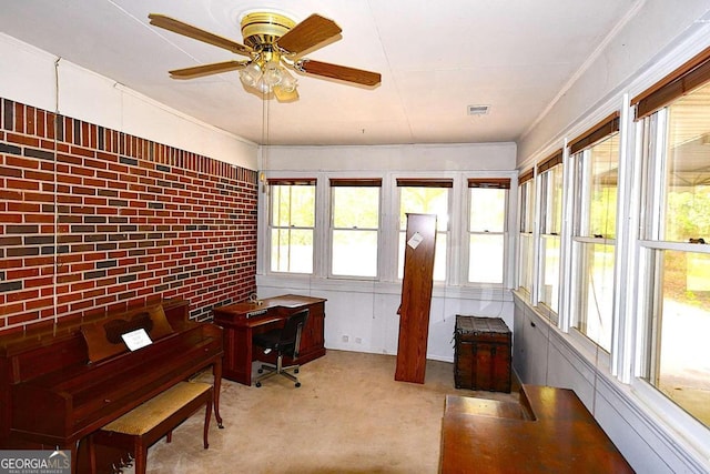 unfurnished sunroom with ceiling fan