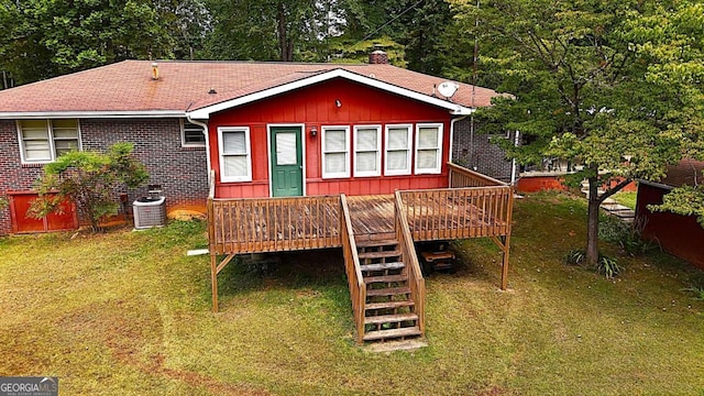 back of house featuring a lawn, central AC, and a deck