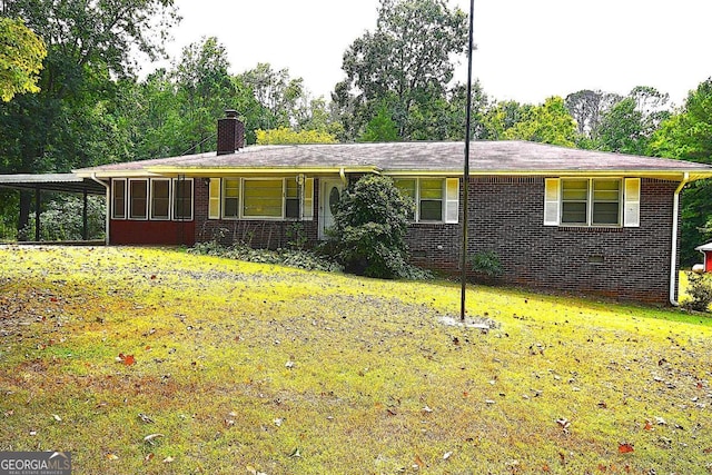 single story home featuring a front lawn and a sunroom