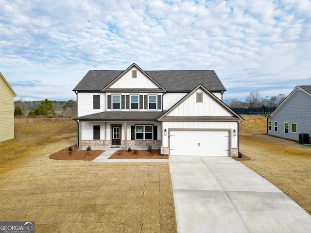 view of front of property featuring a garage, a front yard, and covered porch