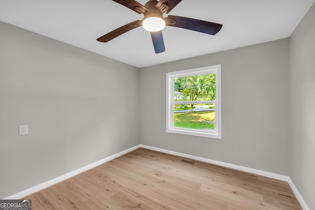 spare room with light wood-type flooring and ceiling fan