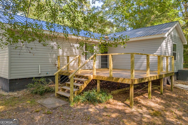 rear view of property featuring a wooden deck