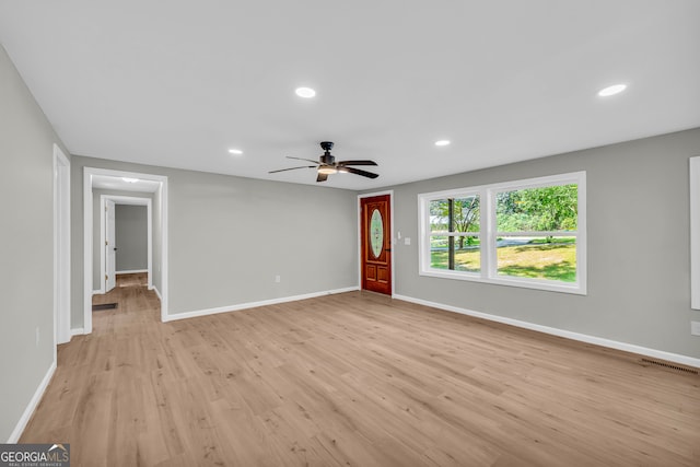 unfurnished room with ceiling fan and light hardwood / wood-style flooring