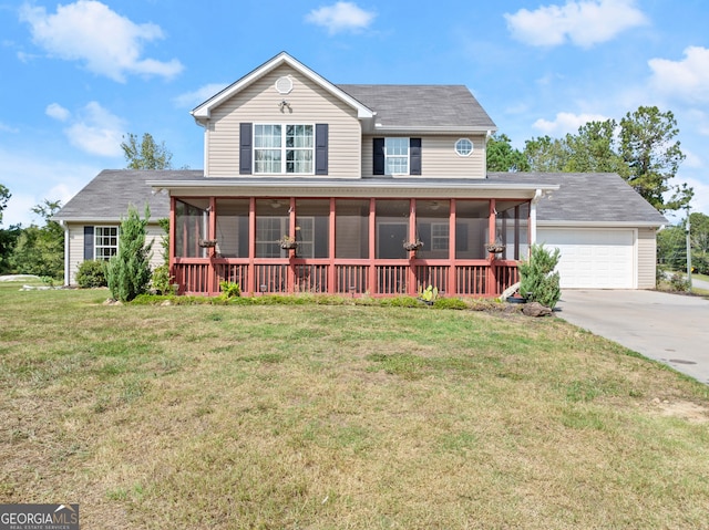 view of front of house with a garage, a sunroom, and a front lawn