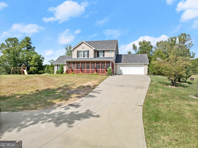 view of front of property with a playground, a front yard, a sunroom, and a garage