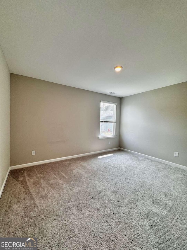 carpeted spare room with a textured ceiling