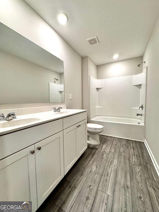 full bathroom featuring toilet, tub / shower combination, hardwood / wood-style flooring, and vanity