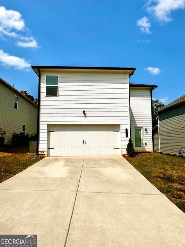 view of home's exterior with a garage, a lawn, and central air condition unit