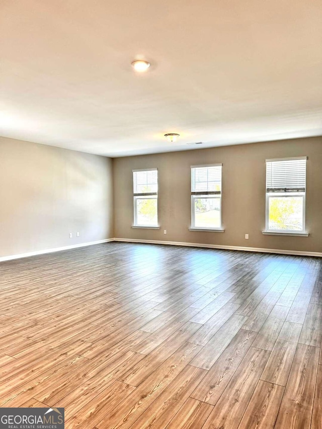 spare room featuring light hardwood / wood-style flooring